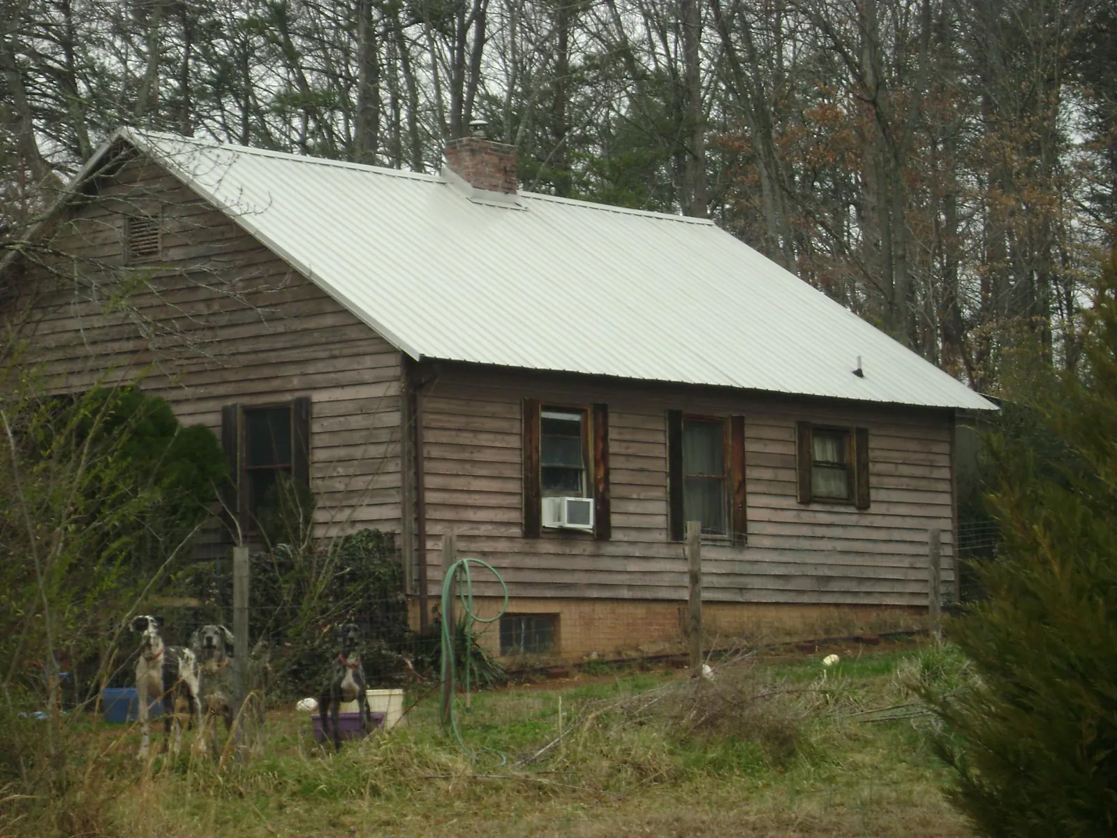 White metal roof on an old wood sided farmhouse, from a Asphalt Shingle Roof Repair job in Andover